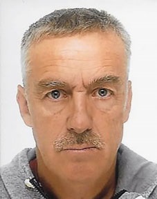 Portrait of Markus Nussbaumer, a man with grey hair and a mustache, wearing a grey jacket.