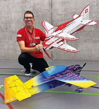 Sylvain PASINI, Pilote F3P-A et F3P-AFM, holding a model aircraft.